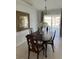 Dining room with a chandelier, wood table, and large windows at 17799 Se 125Th Cir, Summerfield, FL 34491