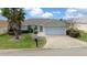 Charming one-story home with a well-maintained lawn and attached two-car garage at 17799 Se 125Th Cir, Summerfield, FL 34491