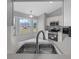 A well-lit kitchen with stainless steel appliances and views of the backyard at 17799 Se 125Th Cir, Summerfield, FL 34491