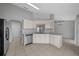 Modern kitchen with white cabinetry, stainless steel appliances, and tiled flooring, perfect for cooking at 17799 Se 125Th Cir, Summerfield, FL 34491