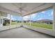 View from the screened lanai overlooking the green lawns of neighboring properties at 17799 Se 125Th Cir, Summerfield, FL 34491