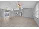 Bright living room features neutral decor, a ceiling fan and tile flooring at 17799 Se 125Th Cir, Summerfield, FL 34491