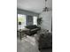 Bright living room featuring neutral tones, tile flooring, and a ceiling fan at 17799 Se 125Th Cir, Summerfield, FL 34491