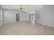 Open-concept living room featuring tile flooring, vaulted ceiling, and access to outdoor space at 17799 Se 125Th Cir, Summerfield, FL 34491