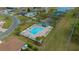 Aerial view of a community pool with lounge chairs and a nearby parking area at 17799 Se 125Th Cir, Summerfield, FL 34491