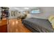 Cozy bedroom featuring hardwood floors, a comfortable bed, and a sitting area with natural light at 18434 Se 24Th St, Silver Springs, FL 34488