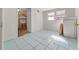 Neutral-toned bedroom with blue tile floor and a shelving unit at 18434 Se 24Th St, Silver Springs, FL 34488