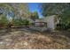 Charming home exterior with a deck, offering a relaxing outdoor space surrounded by lush greenery at 18434 Se 24Th St, Silver Springs, FL 34488