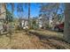 Exterior view of a single story home with neutral siding, a truck parked in the front, and mature trees at 18434 Se 24Th St, Silver Springs, FL 34488