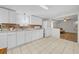 Open kitchen featuring white cabinets, laminate counters, and views into the living space at 18434 Se 24Th St, Silver Springs, FL 34488