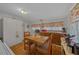 Cozy eat-in kitchen with white cabinets and wood countertop, floral decorations and ample storage space at 18434 Se 24Th St, Silver Springs, FL 34488