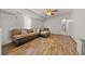 Comfortable living room featuring wood-look floors and a sectional sofa at 18434 Se 24Th St, Silver Springs, FL 34488