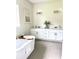 Bathroom features double vanity, soaking tub, neutral color palette, and decorative accents at 1929 Nw 85Th Loop, Ocala, FL 34475