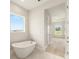 Bathroom featuring a freestanding tub, white tile flooring, and a sunlit window at 1929 Nw 85Th Loop, Ocala, FL 34475