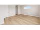 Clean bedroom with wood-style flooring, crisp white trim, and a side window at 1929 Nw 85Th Loop, Ocala, FL 34475