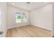Bright bedroom featuring beautiful hardwood floors and two windows letting in ample natural light at 1929 Nw 85Th Loop, Ocala, FL 34475