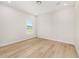 Clean bedroom with light hardwood floors and a window looking out to a well kept green lawn at 1929 Nw 85Th Loop, Ocala, FL 34475