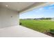 Covered patio with concrete floor offering backyard views with green space and neighborhood at 1929 Nw 85Th Loop, Ocala, FL 34475