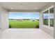 View from covered patio overlooking large backyard with green grass and neighboring homes at 1929 Nw 85Th Loop, Ocala, FL 34475