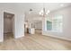 Open-concept dining area showcasing wood floors, modern lighting, and a view of the kitchen at 1929 Nw 85Th Loop, Ocala, FL 34475