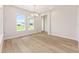 Bright dining room featuring wood-look floors, a chandelier, and natural light at 1929 Nw 85Th Loop, Ocala, FL 34475