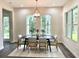 Dining room with large windows offering serene views of the surrounding greenery at 1929 Nw 85Th Loop, Ocala, FL 34475