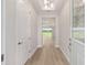 Bright entryway featuring wood-look flooring and decorative glass front door at 1929 Nw 85Th Loop, Ocala, FL 34475