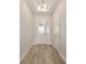 Bright entryway featuring wood-look flooring and a glass-paneled front door at 1929 Nw 85Th Loop, Ocala, FL 34475
