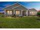 Charming single-story home featuring a welcoming front porch and lush green lawn at 1929 Nw 85Th Loop, Ocala, FL 34475