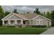 Inviting single-story home showcasing a well-manicured lawn, stone accents, and attached two car garage at 1929 Nw 85Th Loop, Ocala, FL 34475