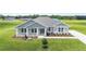 Inviting single-story home with a well-manicured lawn and charming front porch at 1929 Nw 85Th Loop, Ocala, FL 34475