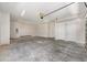 Spacious garage with concrete floors, overhead lighting, and two white doors at 1929 Nw 85Th Loop, Ocala, FL 34475