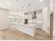 Open concept kitchen with center island, pendant lighting, and stainless steel appliances at 1929 Nw 85Th Loop, Ocala, FL 34475