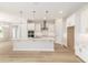 Modern kitchen with white cabinets, stainless steel appliances, and large island, offering ample space at 1929 Nw 85Th Loop, Ocala, FL 34475