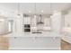 Beautiful white kitchen island with a quartz countertop and stainless steel appliances at 1929 Nw 85Th Loop, Ocala, FL 34475