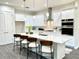 Modern kitchen with stainless steel appliances, a large island, pendant lights, and white cabinets at 1929 Nw 85Th Loop, Ocala, FL 34475