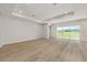 Spacious living room with wood-look floors and large sliding glass doors at 1929 Nw 85Th Loop, Ocala, FL 34475