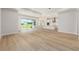 Open-concept living room flows into kitchen with wood-look flooring and lots of natural light at 1929 Nw 85Th Loop, Ocala, FL 34475