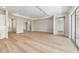 Large living room with wood-look floors connecting to the kitchen and entryway at 1929 Nw 85Th Loop, Ocala, FL 34475