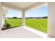 Under-roof patio with a full view to the lawn and the residences beyond the back yard at 1929 Nw 85Th Loop, Ocala, FL 34475