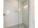 Modern walk-in shower featuring white subway tile, glass door, and recessed niche at 1929 Nw 85Th Loop, Ocala, FL 34475