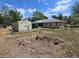 Backyard featuring a storage shed, some grass, and screened-in porch at 22 Hemlock Ter, Ocala, FL 34472