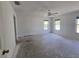 Large bedroom with abundant natural light from dual windows and ceiling fan at 22 Hemlock Ter, Ocala, FL 34472