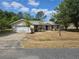 Single-Gathering home with a two-car garage and a well-maintained, though dry, front yard at 22 Hemlock Ter, Ocala, FL 34472
