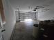 Spacious garage with overhead lighting and large door, offering ample storage and parking at 22 Hemlock Ter, Ocala, FL 34472