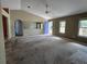 Spacious living room showcasing vaulted ceilings, carpet flooring, and abundant natural light at 22 Hemlock Ter, Ocala, FL 34472