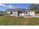 Charming single-story home with gray stucco exterior, manicured lawn, and attached garage at 2275 Sw 146Th Ct, Ocala, FL 34481