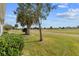 Backyard showcasing the lawn and landscaping with a view of the golf course at 2399 Nw 53Rd Avenue Rd, Ocala, FL 34482
