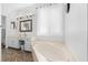 Bright bathroom with a soaking tub, vanity with ample countertop space, and decorative lighting at 2399 Nw 53Rd Avenue Rd, Ocala, FL 34482