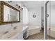 Spacious bathroom with dual sinks, a soaking tub, and separate glass shower enclosure at 2399 Nw 53Rd Avenue Rd, Ocala, FL 34482